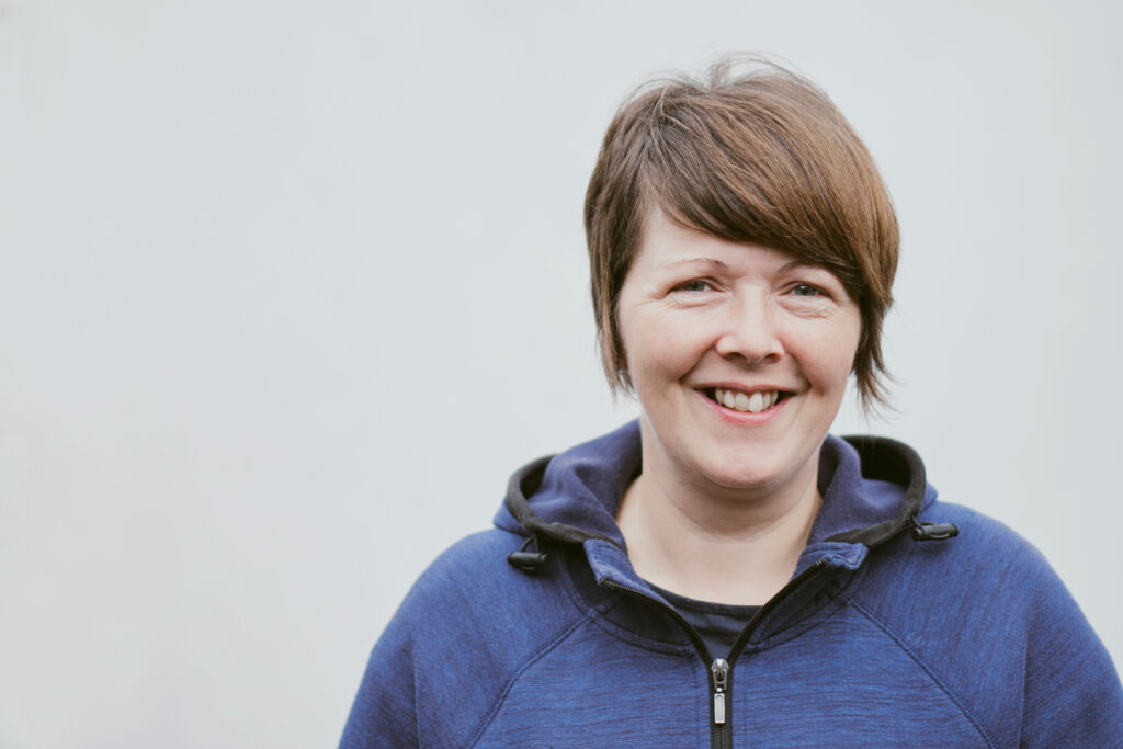 A women posing for an image smiling into the camera