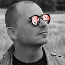 An image showing Artist Michael Forbes wearing sunglasses in greyscale 