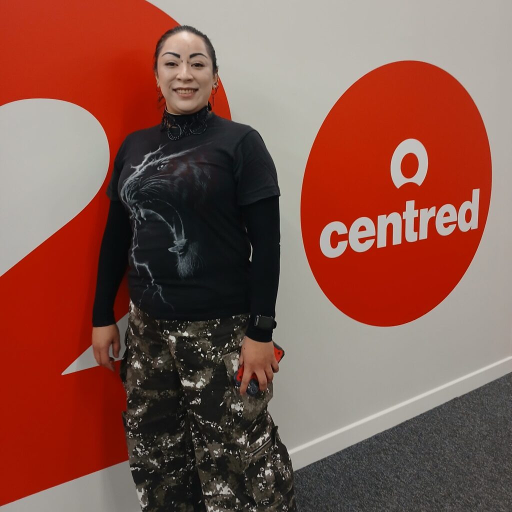 A Image showing Monette Walker standing next to the Centred Logo